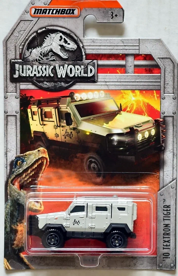 Voiture de collection Matchbox '10 Textron Tiger blanche dans son emballage thématique Jurassic World avec illustration d'un dinosaure et un volcan en arrière-plan.