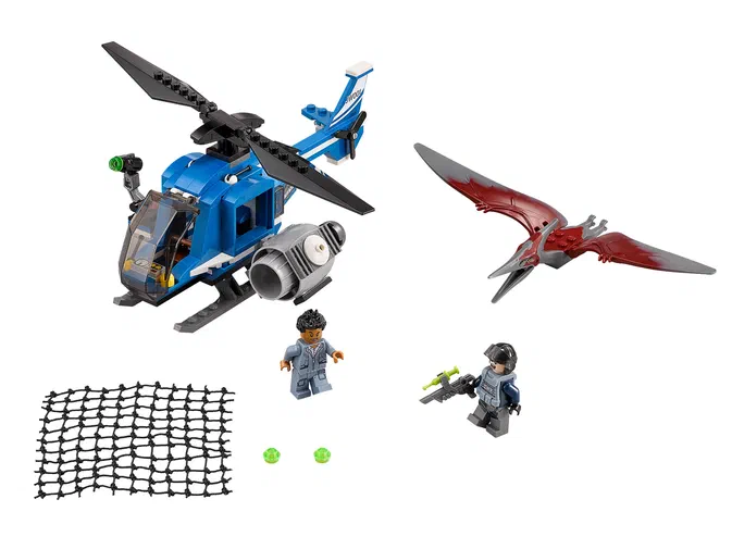 Un ensemble de pièces LEGO montrant un hélicoptère bleu, un Pteranodon rouge en vol, deux minifigures et un filet noir dans une scène de capture.