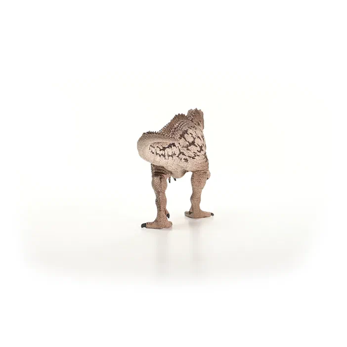 Jouet d'un dinosaure Carcharodontosaurus Schleich vu par l'arrière, debout sur fond blanc.
