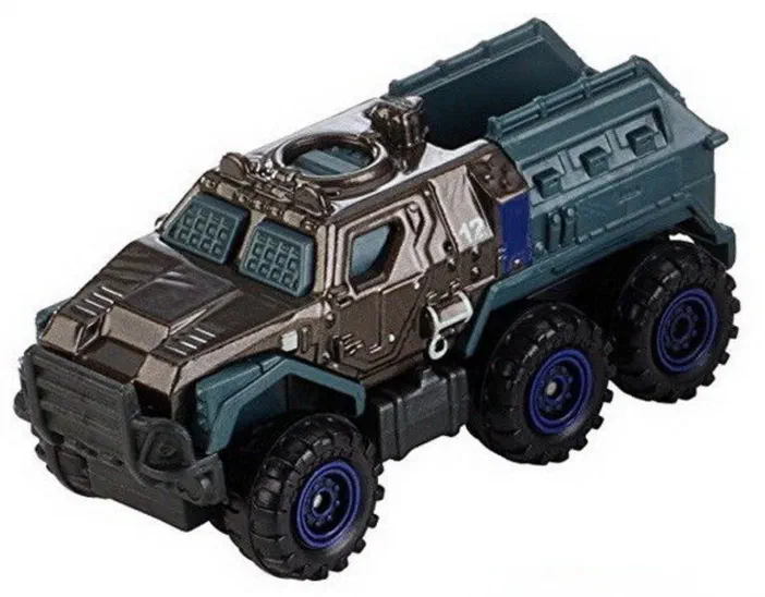 Un camion jouet à six roues avec des pneus larges aux jantes bleues, une cabine gris foncé et un compartiment arrière vert-bleu sur fond blanc.
