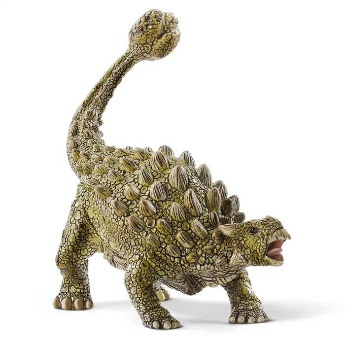 Une figurine de dinosaure vert à écailles et plaques dorsales proéminentes, la bouche ouverte avec la queue levée en position défensive.