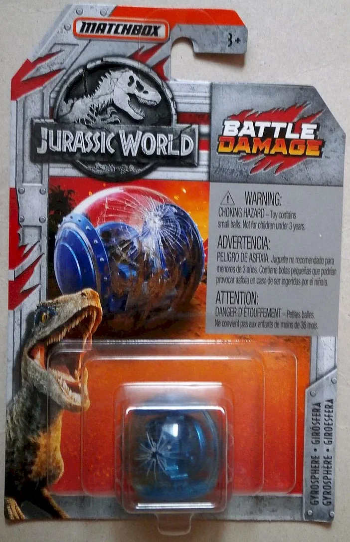 Jouet Matchbox Gyrosphere de la série Jurassic World (2018), présenté avec des dommages de combat sur son packaging orange et gris.