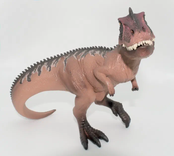 Figurine de dinosaure T-Rex en position debout sur fond blanc.