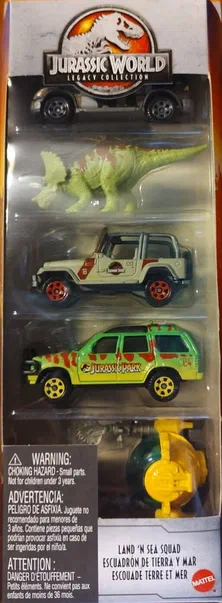 Boîte de collection Matchbox Jurassic World Legacy contenant quatre véhicules : une voiture noire, un dinosaure vert, deux SUV et un sous-marin jaune.