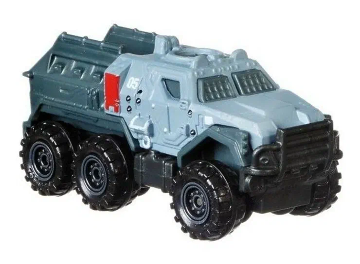 Puce Matchbox Armored Action Truck de la série Jurassic World (2018), gris clair et noir avec six roues.
