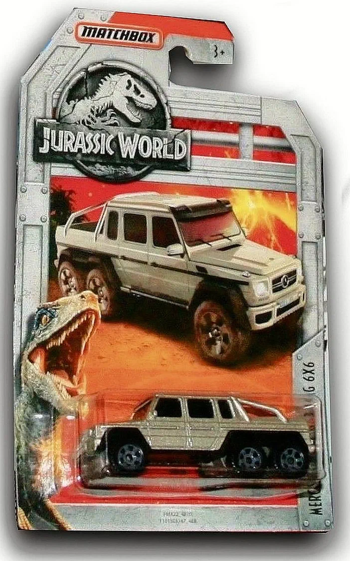 Packaging Matchbox de la voiture Mercedes-Benz G63 AMG 6x6 (Jurassic World) avec une dinosaure en bas à gauche.