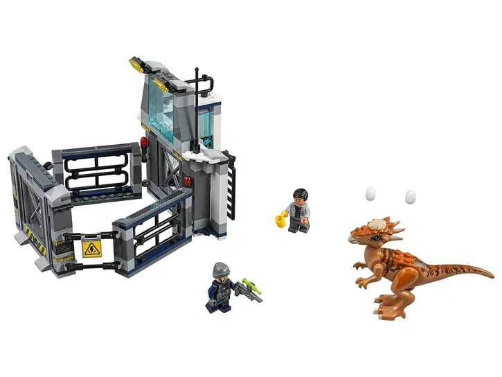 Ensemble de construction LEGO Jurassic World : une base grise avec des barrières et deux minifigurmes près d'un Stygimoloch orange et de deux œufs blancs.