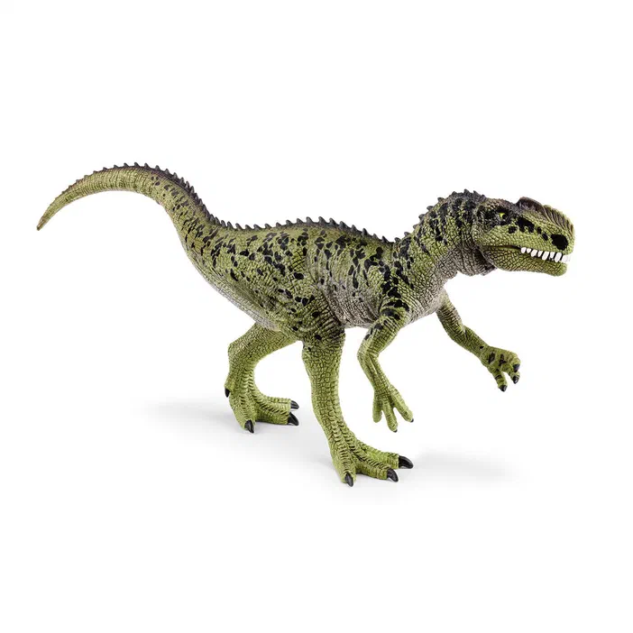 Figurine de dinosaure Monolophosaurus vert et noir sur fond blanc.
