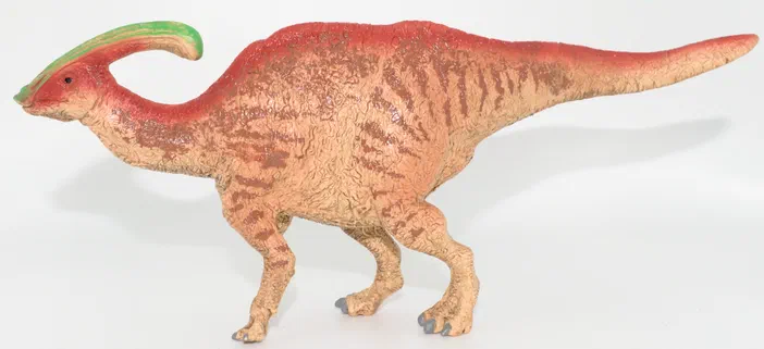Un jouet de dinosaure Parasaurolophus Schleich, avec un bec rouge et une crête verte.