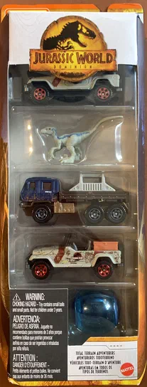 Boîte de jouets Matchbox Jurassic World Dominion contenant quatre véhicules : un Gyrosphere bleu, deux Jeep Wrangler et une Off-Road Rescue Rig.