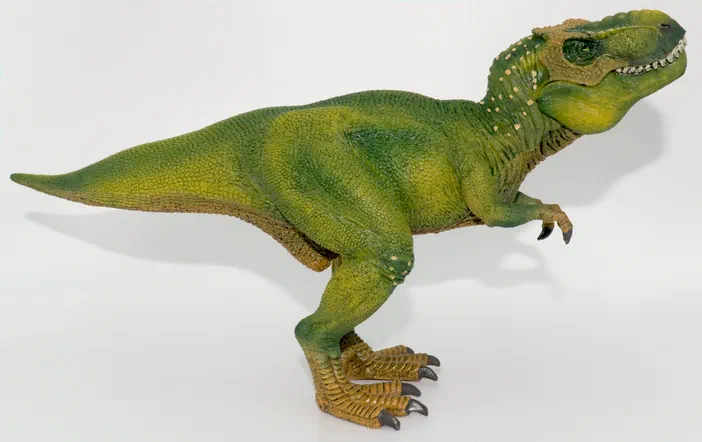 Figurine de dinosaure T-Rex verte sur fond blanc