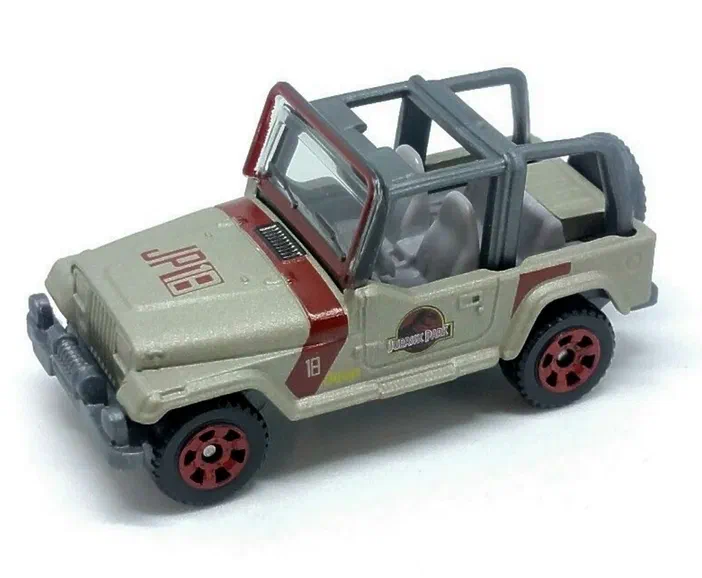 Jouet Matchbox Jeep Wrangler beige avec une bande rouge et le logo Jurassic Park.