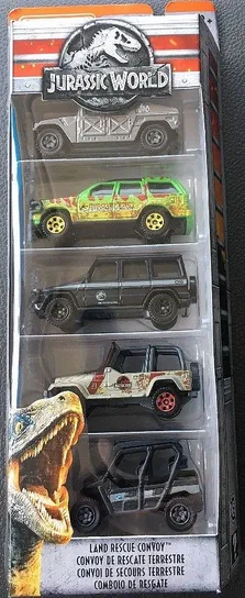 Packaging de Matchbox Jurassic World contenant cinq véhicules terrestres : une InGen Humvee, un Ford Explorer vert, un Mercedes G550 noir, un Jeep Wrangler blanc et un Kawasaki Teryx4 LE.