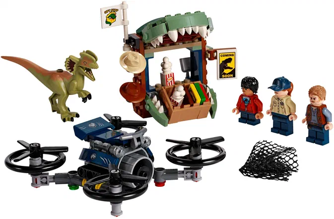 Ensemble de figurines LEGO Jurassic World incluant un dinosaure, une structure avec des dents et trois personnages humains.